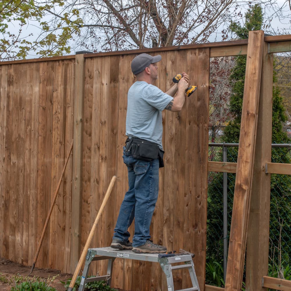 Fence contractor building a fence